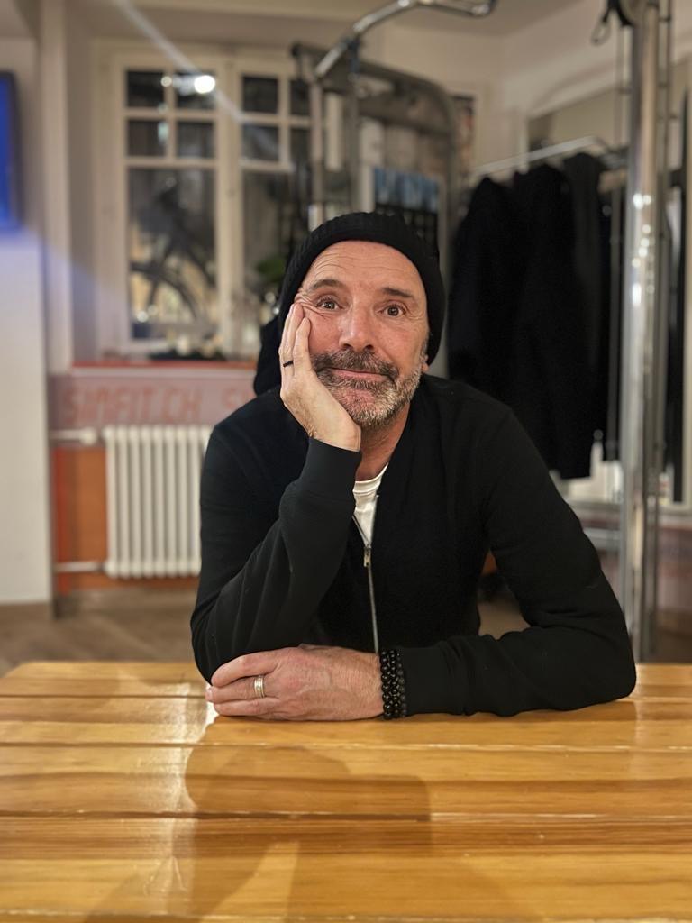 grayscale photography of two people raising their hands